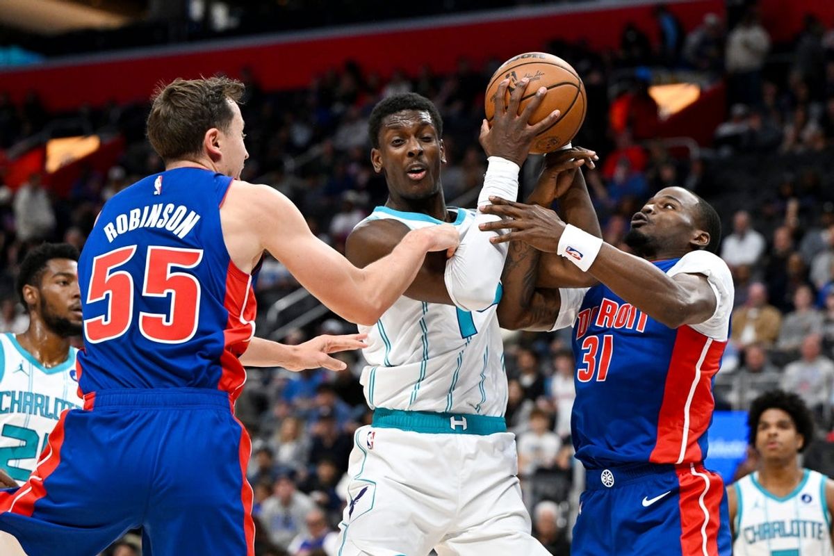 Oct 28, 2026; Detroit, Michigan, USA;  Charlotte Hornets forward Moussa Diabate (14) gets fouled by Detroit Pistons forward Duncan Robinson (55) and guard Javonte Green (31) while driving to the basket in the first quarter at Little Caesars Arena.  Mandatory Credit: Lon Horwedel-Imagn Images