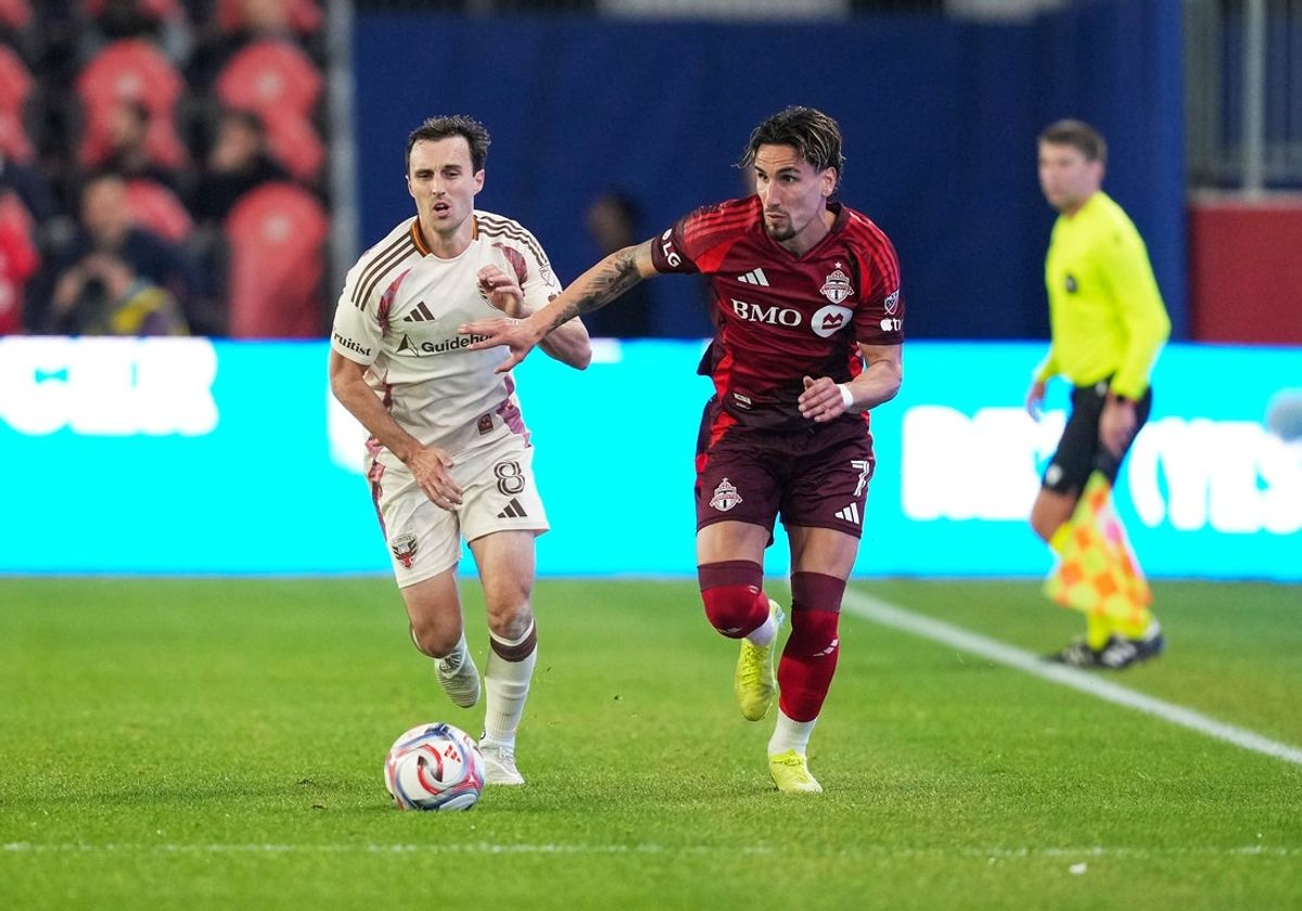 Oct 28, 2026; Toronto, Ontario, CAN;  Toronto FC forward Theo Corbeanu (7) battles for the ball with D.C. United midfielder Jared Stroud (8) during the first half at BMO Field.  Mandatory Credit: Nick Turchiaro-Imagn Images