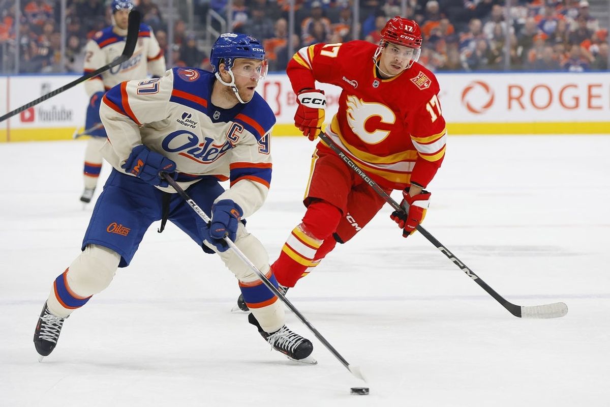 Oct 28, 2026; Edmonton, Alberta, CAN;  Edmonton Oilers forward Connor McDavid (97) /looks to make a play in front of Calgary Flames forward Yegor Sharangovich (17) during the first period at Rogers Place.  Mandatory Credit: Perry Nelson-Imagn Images