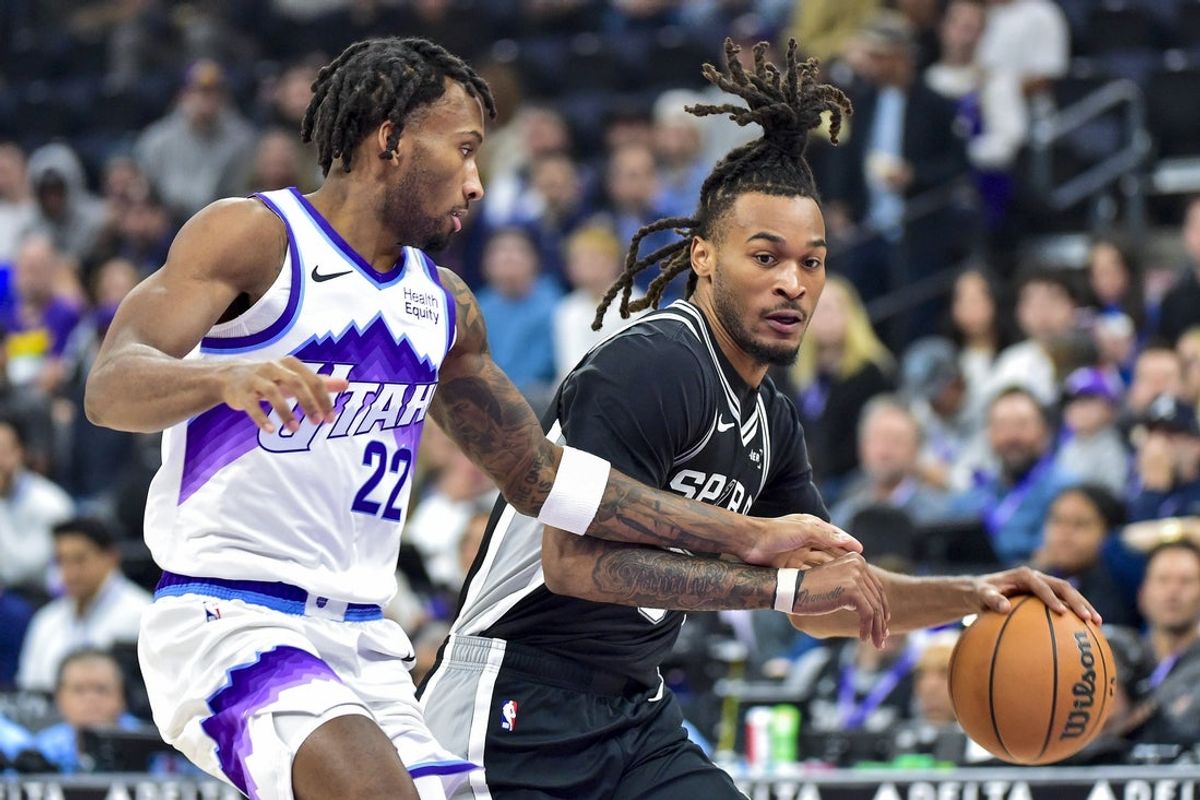 Oct 28, 2026; Salt Lake City, Utah, USA;  San Antonio Spurs guard Stephon Castle (5) looks to make a move around Utah Jazz guard Darryn Peterson (22) during the first half at Delta Center.  Mandatory Credit: Peter Creveling-Imagn Images