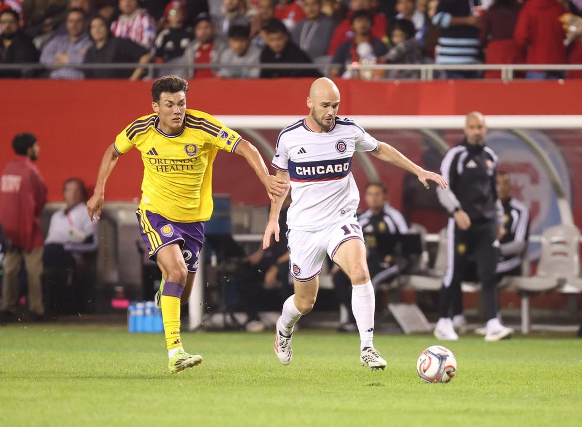 Oct 28, 2026; Chicago, Illinois, USA; Orlando City forward Justin Ellis (22) and Chicago Fire defender Andrew Gutman (15) battle for control of the ball during the first half at Soldier Field. Mandatory Credit: Talia Sprague-Imagn Images