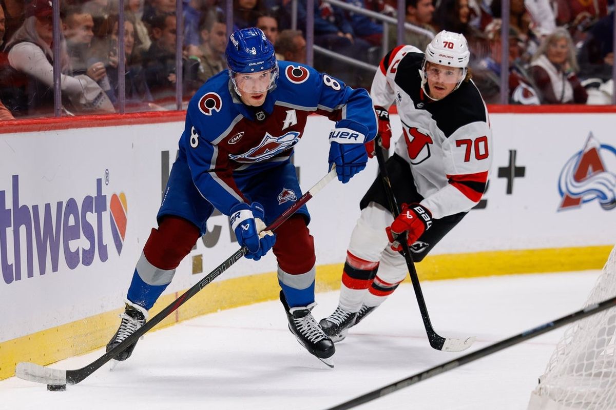 Oct 28, 2026; Denver, Colorado, USA; Colorado Avalanche defenseman Cale Makar (8) controls the puck ahead of New Jersey Devils center Jesper Boqvist (70) in the first period at Ball Arena. Mandatory Credit: Isaiah J. Downing-Imagn Images