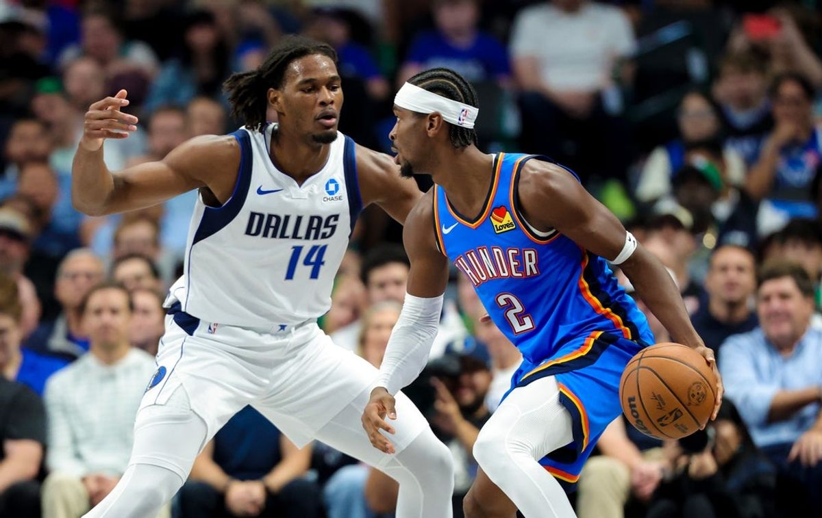 Oct 28, 2026; Dallas, Texas, USA;  Oklahoma City Thunder guard Shai Gilgeous-Alexander (2) dribbles as Dallas Mavericks forward Morez Johnson Jr. (14) defends during the first quarter at American Airlines Center. Mandatory Credit: Kevin Jairaj-Imagn Images