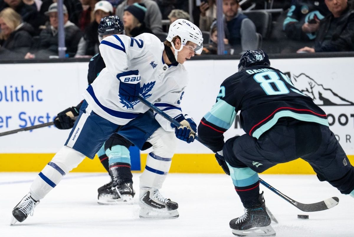 Oct 28, 2026; Seattle, Washington, USA; Toronto Maple Leafs forward Gavin McKenna (92), left, skates against Seattle Kraken forward Frederick Gaudreau (89) during the second period at Climate Pledge Arena. Mandatory Credit: Stephen Brashear-Imagn Images