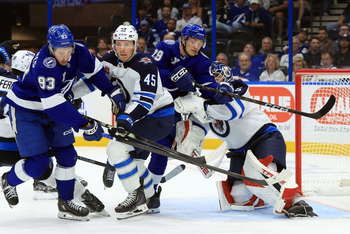 Oct 29, 2026; Tampa, Florida, USA;  Tampa Bay Lightning center Gage Goncalves (93), Tampa Bay Lightning right wing Pontus Holmberg (29), Winnipeg Jets left wing Cole Koepke (45) and Winnipeg Jets goaltender Nico Daws (35) skate after the puck during the third period at Benchmark International Arena.  Mandatory Credit: Kim Klement Neitzel-Imagn Images