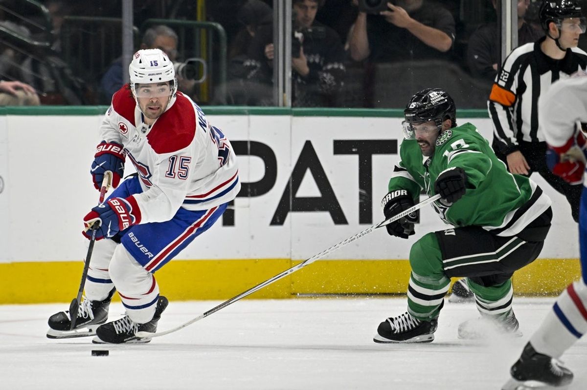Oct 29, 2026; Dallas, Texas, USA; Montreal Canadiens center Alex Newhook (15) skates with the puck in front of Dallas Stars center Colin Blackwell (15) during second period at American Airlines Center. Mandatory Credit: Jerome Miron-Imagn Images