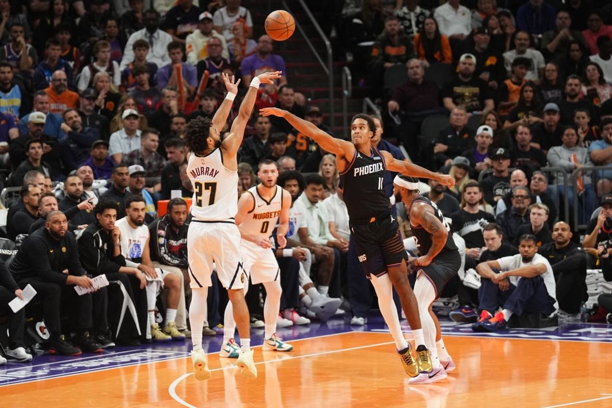 Oct 30, 2026; Phoenix, Arizona, USA; Denver Nuggets guard Jamal Murray (27) shoots over Phoenix Suns forward Oso Ighodaro (11) during the second half at Mortgage Matchup Center. Mandatory Credit: Joe Camporeale-Imagn Images
