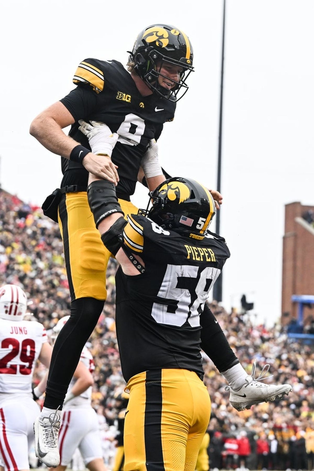 Oct 31, 2026; Iowa City, Iowa, USA;  Iowa Hawkeyes quarterback Hank Brown (9) and offensive lineman Kade Pieper (58) react after the Hawkeyes score a touchdown against the Wisconsin Badgers during the second quarter at Kinnick Stadium.  Mandatory Credit: Jeffrey Becker-Imagn Images