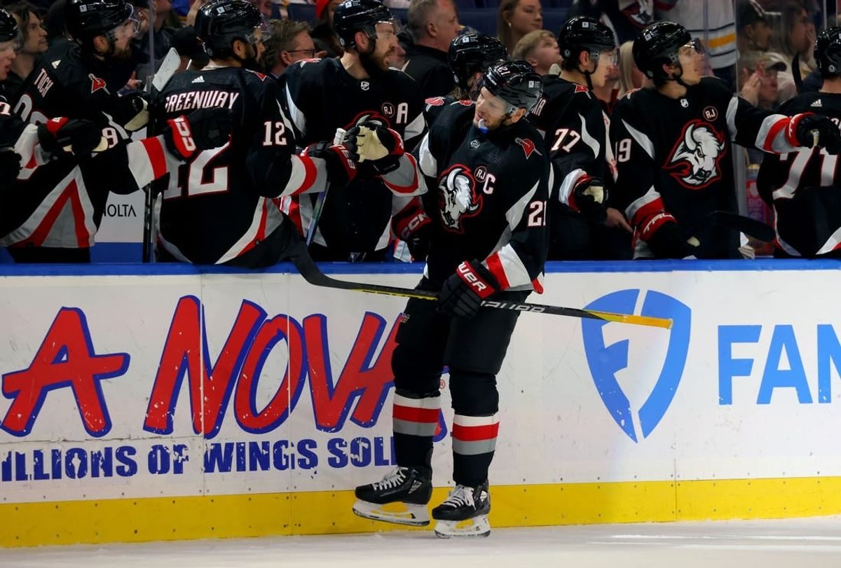 Feb 13, 2024; Buffalo, New York, USA;  Buffalo Sabres right wing Kyle Okposo (21) celebrates his goal with teammates during the first period against the Los Angeles Kings at KeyBank Center.