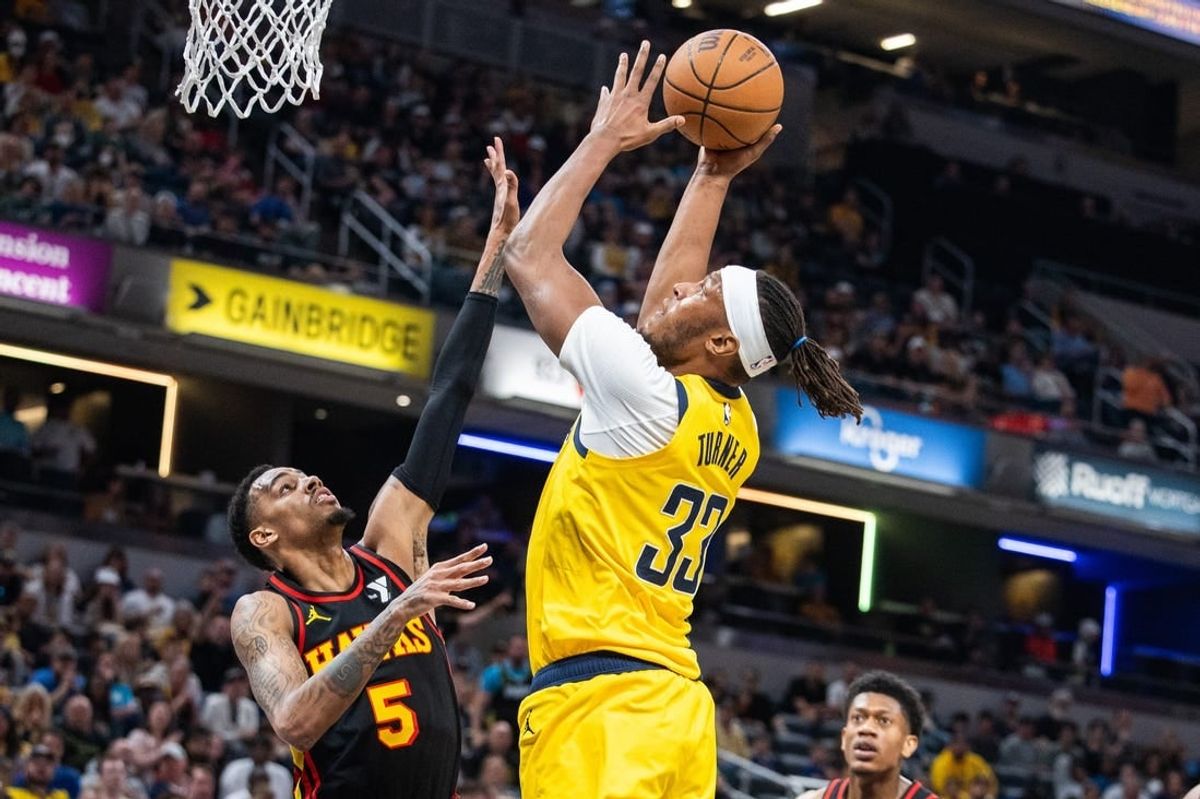 Apr 14, 2024; Indianapolis, Indiana, USA; Indiana Pacers center Myles Turner (33) shoots the ball while Atlanta Hawks guard Dejounte Murray (5) defends in the first half at Gainbridge Fieldhouse.