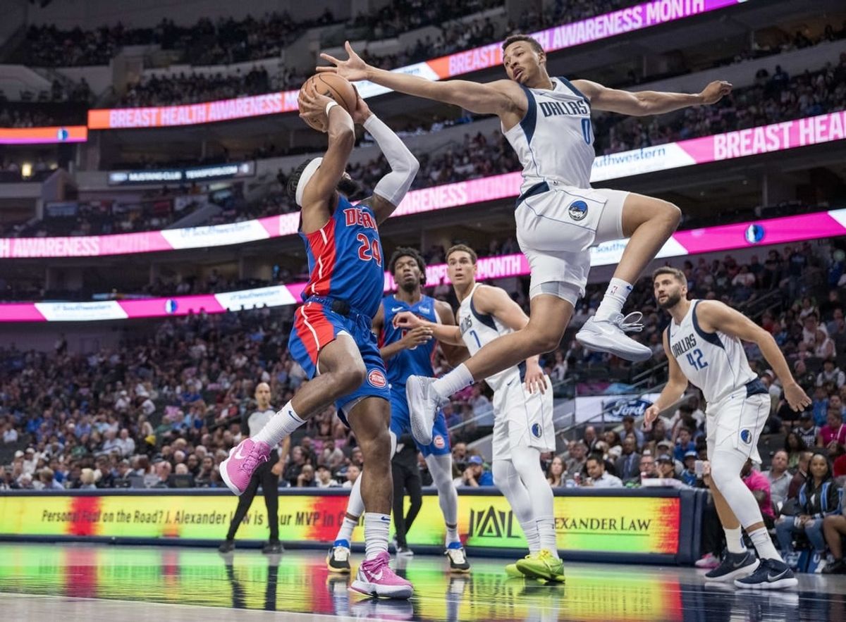Oct 20, 2023; Dallas, Texas, USA; Dallas Mavericks guard Dante Exum (0) attempts to block a shot by Detroit Pistons guard Zavier Simpson (24) during the second half at the American Airlines Center.