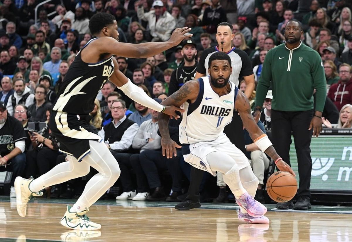Nov 18, 2023; Milwaukee, Wisconsin, USA; Dallas Mavericks guard Kyrie Irving (11) drives to the basket against Milwaukee Bucks guard Cameron Payne (15) in the second half at Fiserv Forum.