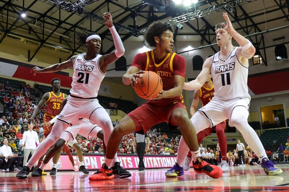 Nov 23, 2023; Kissimmee, Florida, USA;  Iowa State Cyclones guard Curtis Jones (5) look to pass the ball guarded by Virginia Commonwealth Rams forward Christian Fermin (21) and guard Max Shulga (11) in the first half  in the first half during the ESPN Events Invitational at State Farm Field House.