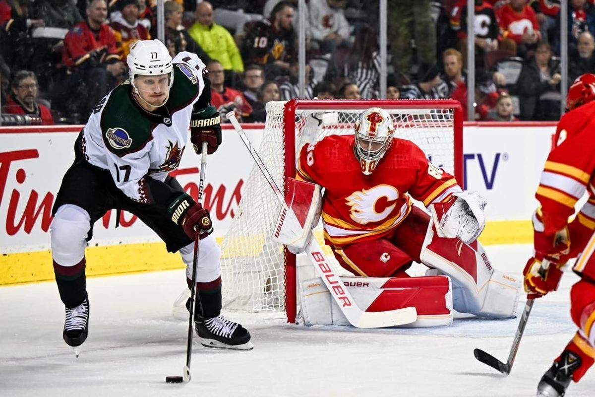 Jan 16, 2024; Calgary, Alberta, CAN; Calgary Flames goaltender Daniel Vladar (80) keeps his eye on Arizona Coyotes center Nick Bjugstad (17) and the puck during the first period at Scotiabank Saddledome.