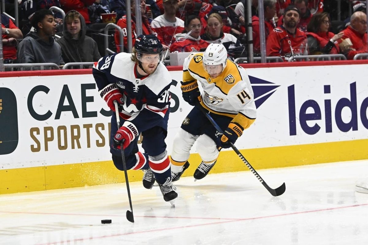 Dec 30, 2023; Washington, District of Columbia, USA; Washington Capitals defenseman Rasmus Sandin (38) advances the puck as Nashville Predators center Gustav Nyquist (14) chases during the second period at Capital One Arena.