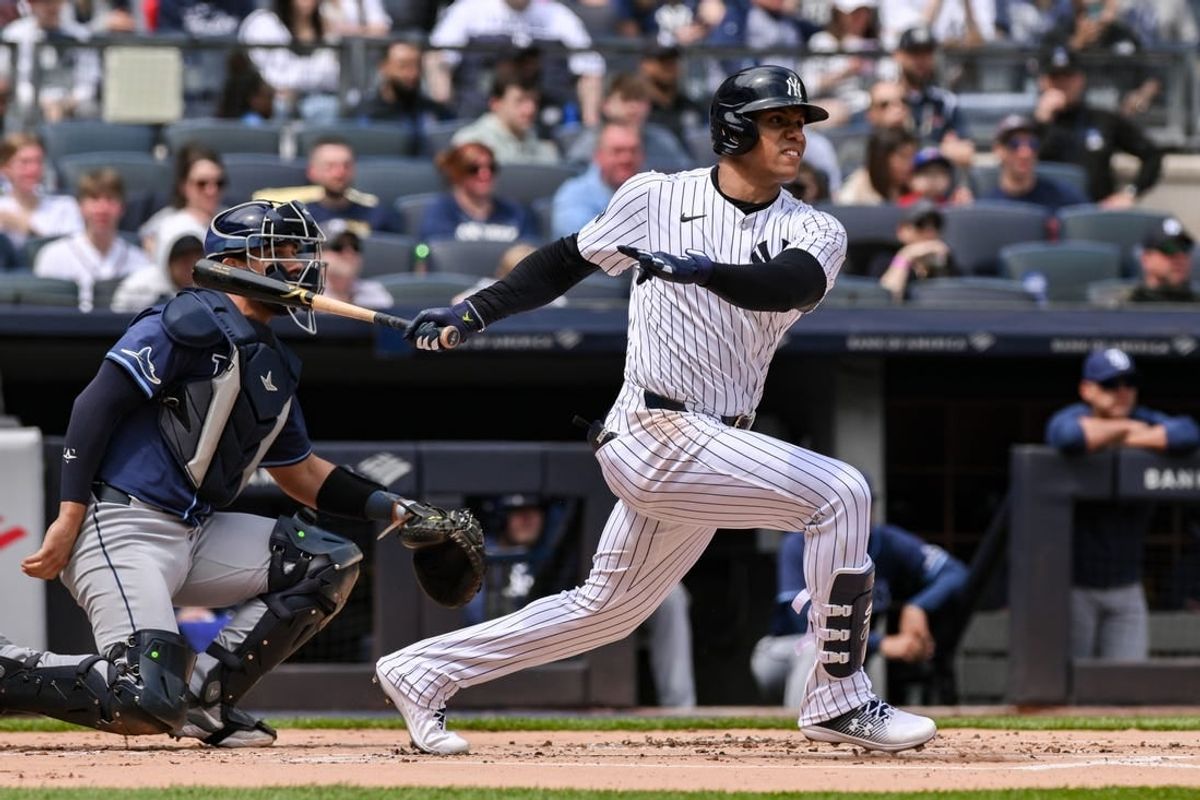 Apr 20, 2024; Bronx, New York, USA; New York Yankees outfielder Juan Soto (22) hits a single against the Tampa Bay Rays during the first inning at Yankee Stadium.