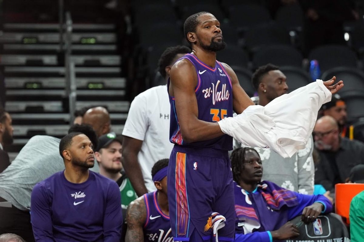 Mar 9, 2024; Phoenix, Arizona, USA; Phoenix Suns forward Kevin Durant (35) looks on from the bench during the second half against the Boston Celtics at Footprint Center.