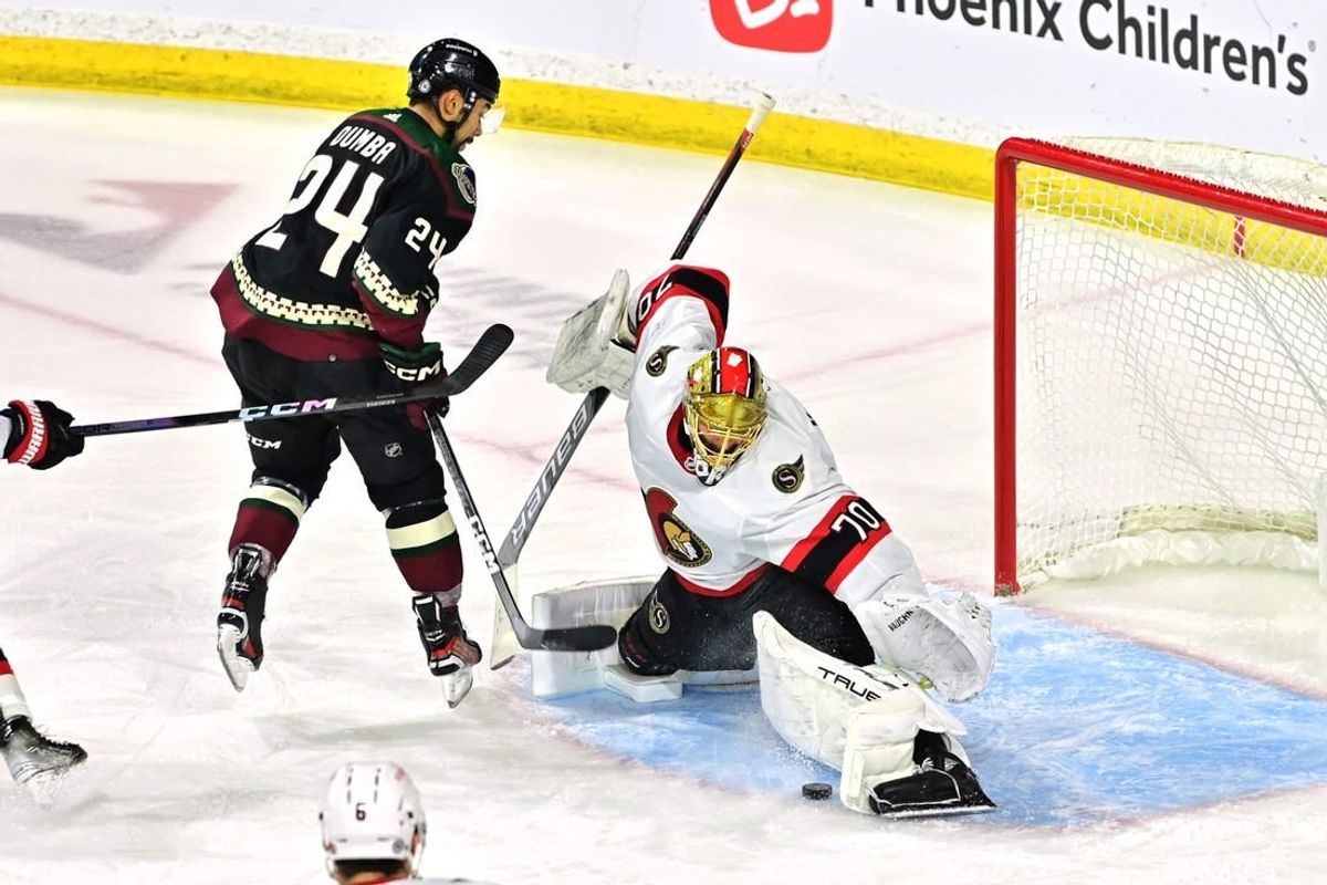 Dec 19, 2023; Tempe, Arizona, USA; Ottawa Senators goaltender Joonas Korpisalo (70) makes a save on Arizona Coyotes defenseman Matt Dumba (24) in the first period at Mullett Arena.