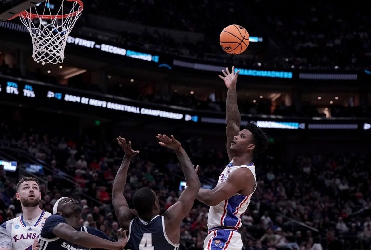 Mar 21, 2024; Salt Lake City, UT, USA; Kansas Jayhawks forward K.J. Adams Jr. (24) shoots against Samford Bulldogs forward Jermaine Marshall (4) during the second half in the first round of the 2024 NCAA Tournament at Vivint Smart Home Arena-Delta Center.