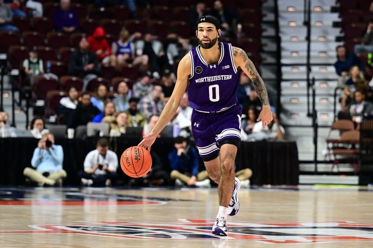 Nov 18, 2023; Uncasville, Connecticut, USA; Northwestern Wildcats guard Boo Buie (0) dribbles the ball against the Rhode Island Rams during the second half at Mohegan Sun Arena.