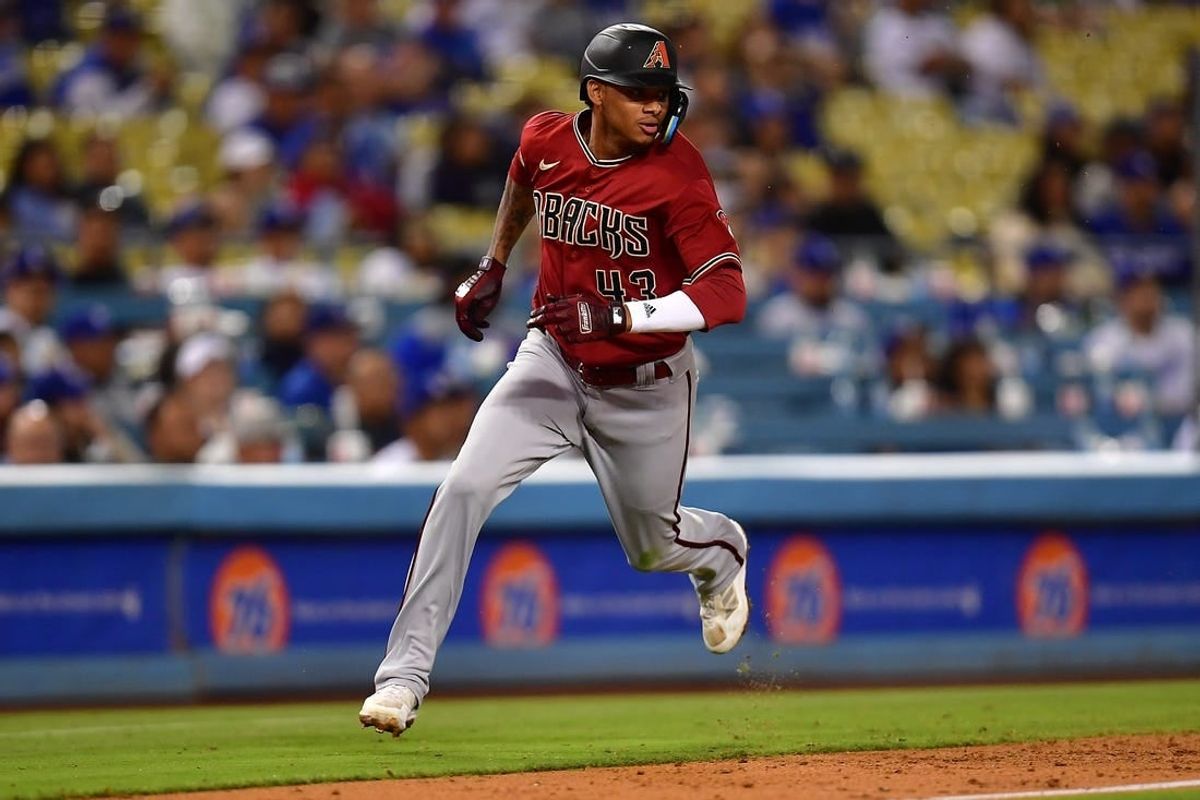 Sep 20, 2022; Los Angeles, California, USA; Arizona Diamondbacks shortstop Sergio Alcantara (43) scores a run against the Los Angeles Dodgers during the ninth inning at Dodger Stadium.