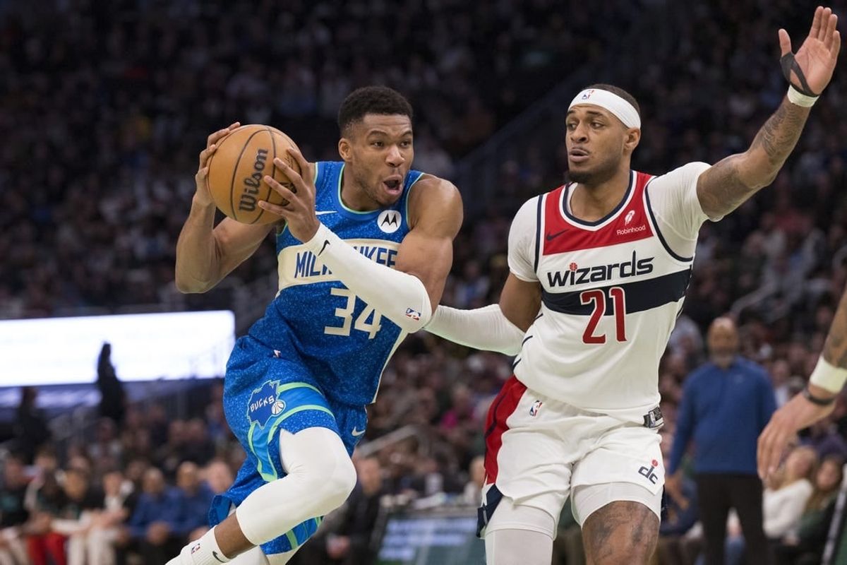Nov 24, 2023; Milwaukee, Wisconsin, USA;  Milwaukee Bucks forward Giannis Antetokounmpo (34) drives for the basket against Washington Wizards center Daniel Gafford (21) during the fourth quarter at Fiserv Forum.