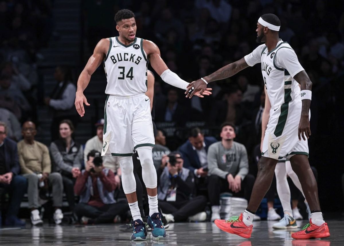 Dec 27, 2023; Brooklyn, New York, USA; Milwaukee Bucks forward Giannis Antetokounmpo (34) slaps hands with forward Bobby Portis (9) during the first half against the Brooklyn Nets at Barclays Center.