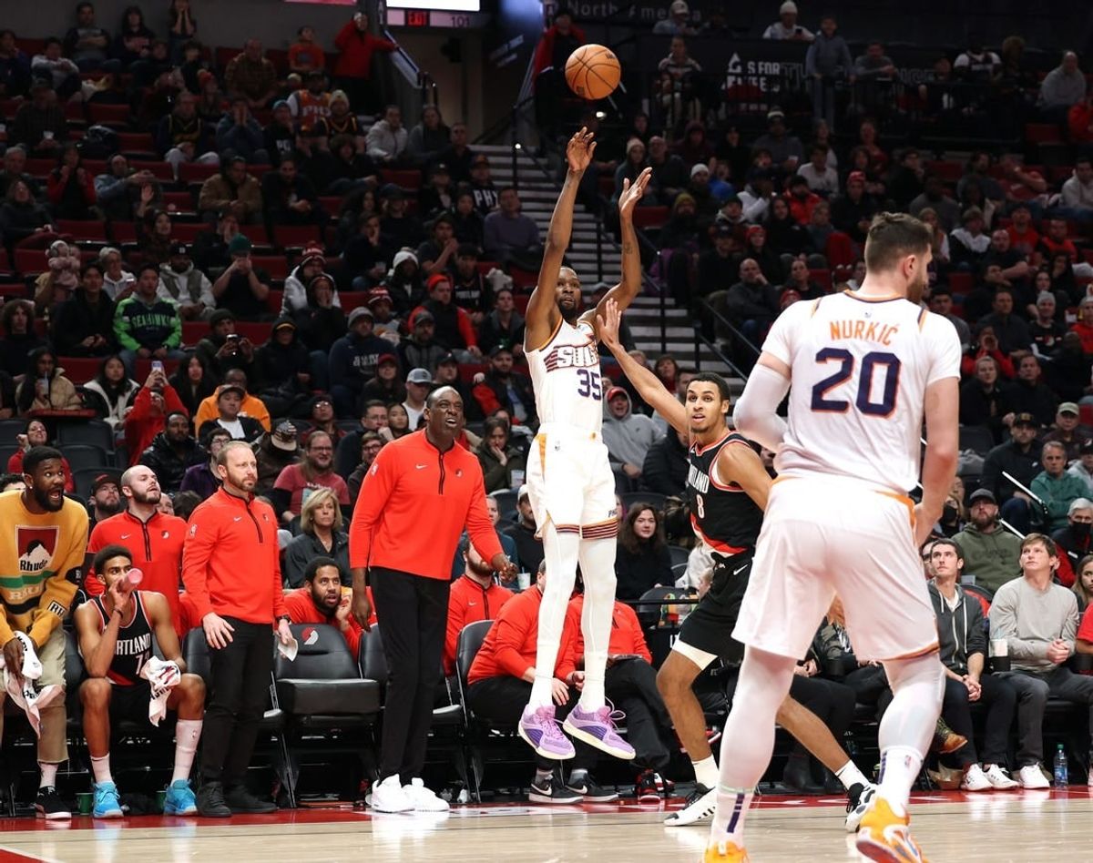 Jan 14, 2024; Portland, Oregon, USA; Phoenix Suns forward Kevin Durant (35) shoots a three-point shot over Portland Trail Blazers forward Kris Murray (8) as Phoenix Suns center Jusuf Nurkic (20) looks on in the fourth quarter at Moda Center.