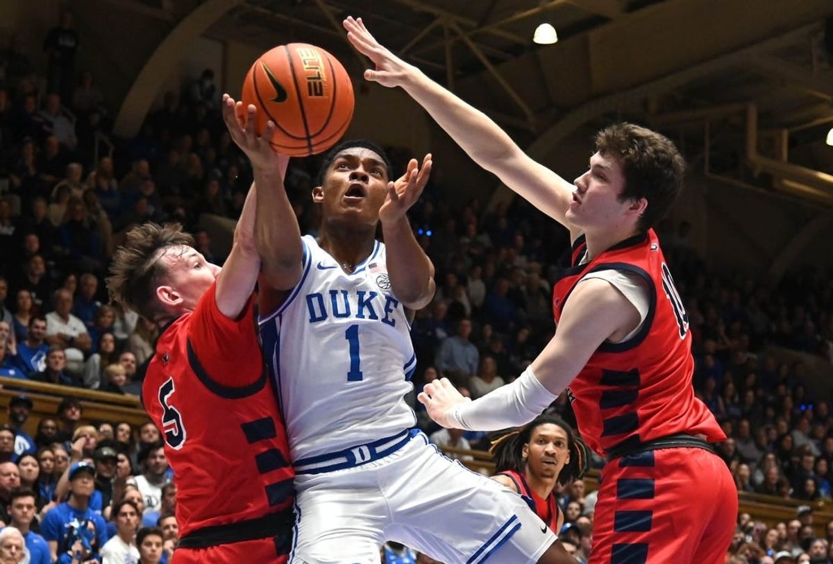 Nov 24, 2023; Durham, North Carolina, USA; Duke Blue Devils guard Caleb Foster (1) lays the ball up between Southern Indiana Screaming Eagles forward Jack Mielke (10) and guard Jack Campion (5) during the second half at Cameron Indoor Stadium.