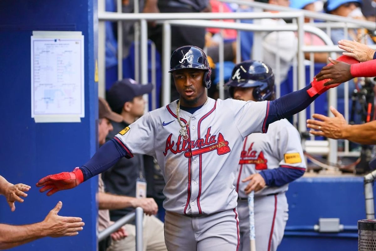 Apr 14, 2024; Miami, Florida, USA; Atlanta Braves second baseman Ozzie Albies (1) celebrates after scoring against the Miami Marlins during the third inning at loanDepot Park.