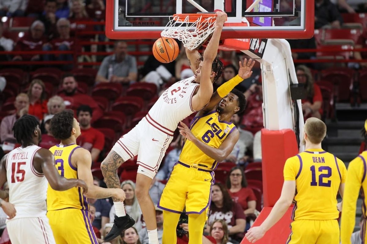 Mar 6, 2024; Fayetteville, Arkansas, USA; Arkansas Razorbacks forward Trevon Brazile (2) dunks the ball in the first half as LSU Tigers guard Jordan Wright (6) defends at Bud Walton Arena.