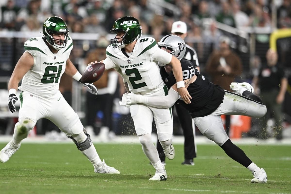 Nov 12, 2023; Paradise, Nevada, USA; New York Jets quarterback Zach Wilson (2) is tackled by Las Vegas Raiders defensive end Maxx Crosby (98) in the first quarter at Allegiant Stadium.