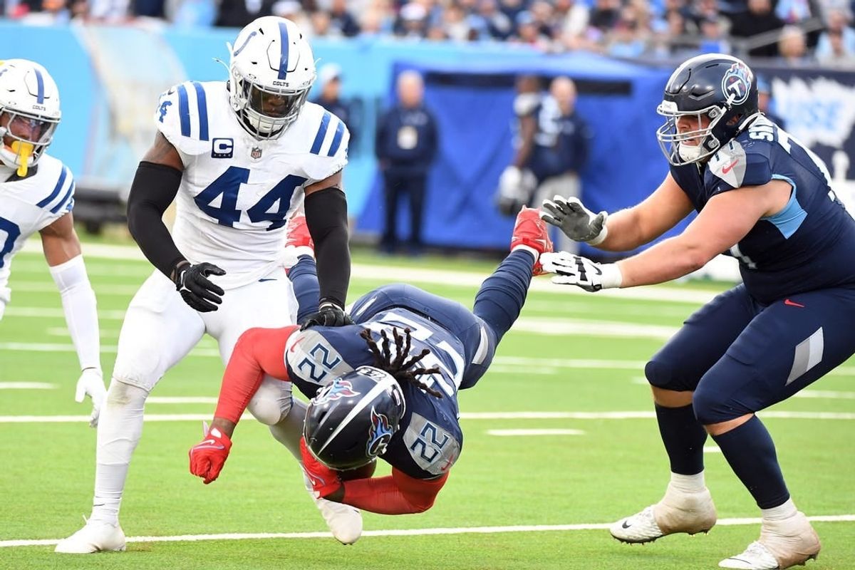 Dec 3, 2023; Nashville, Tennessee, USA; Tennessee Titans running back Derrick Henry (22) is tackled by Indianapolis Colts linebacker Zaire Franklin (44) during the second half at Nissan Stadium.