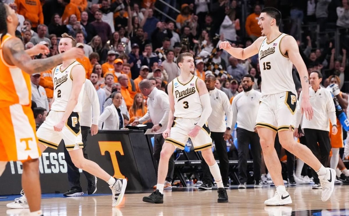 Purdue Boilermakers guard Fletcher Loyer (2), Purdue Boilermakers guard Braden Smith (3) and Purdue Boilermakers center Zach Edey (15) celebrate Sunday, March 31, 2024, after defeating the Tennessee Volunteers for the midwest regional championship at the Little Caesars Arena in Detroit.