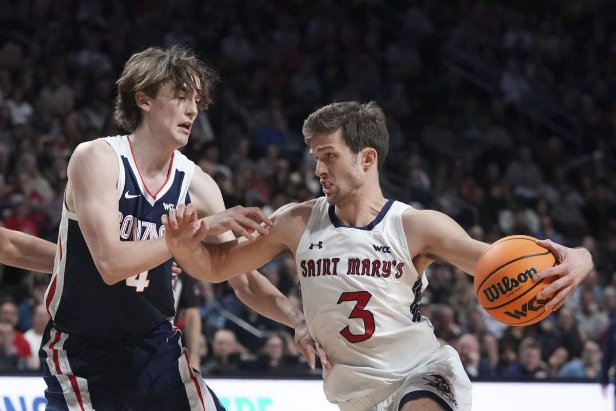 March 12, 2024; Las Vegas, NV, USA; Saint Mary's Gaels guard Augustas Marciulionis (3) dribbles the basketball against Gonzaga Bulldogs guard Dusty Stromer (4) during the first half in the finals of the WCC Basketball Championship at Orleans Arena.