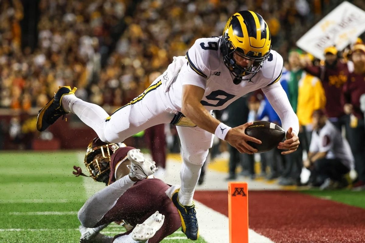 Oct 7, 2023; Minneapolis, Minnesota, USA; Michigan Wolverines quarterback J.J. McCarthy (9) dives for a  touchdown against the Minnesota Golden Gophers during the second quarter at Huntington Bank Stadium.