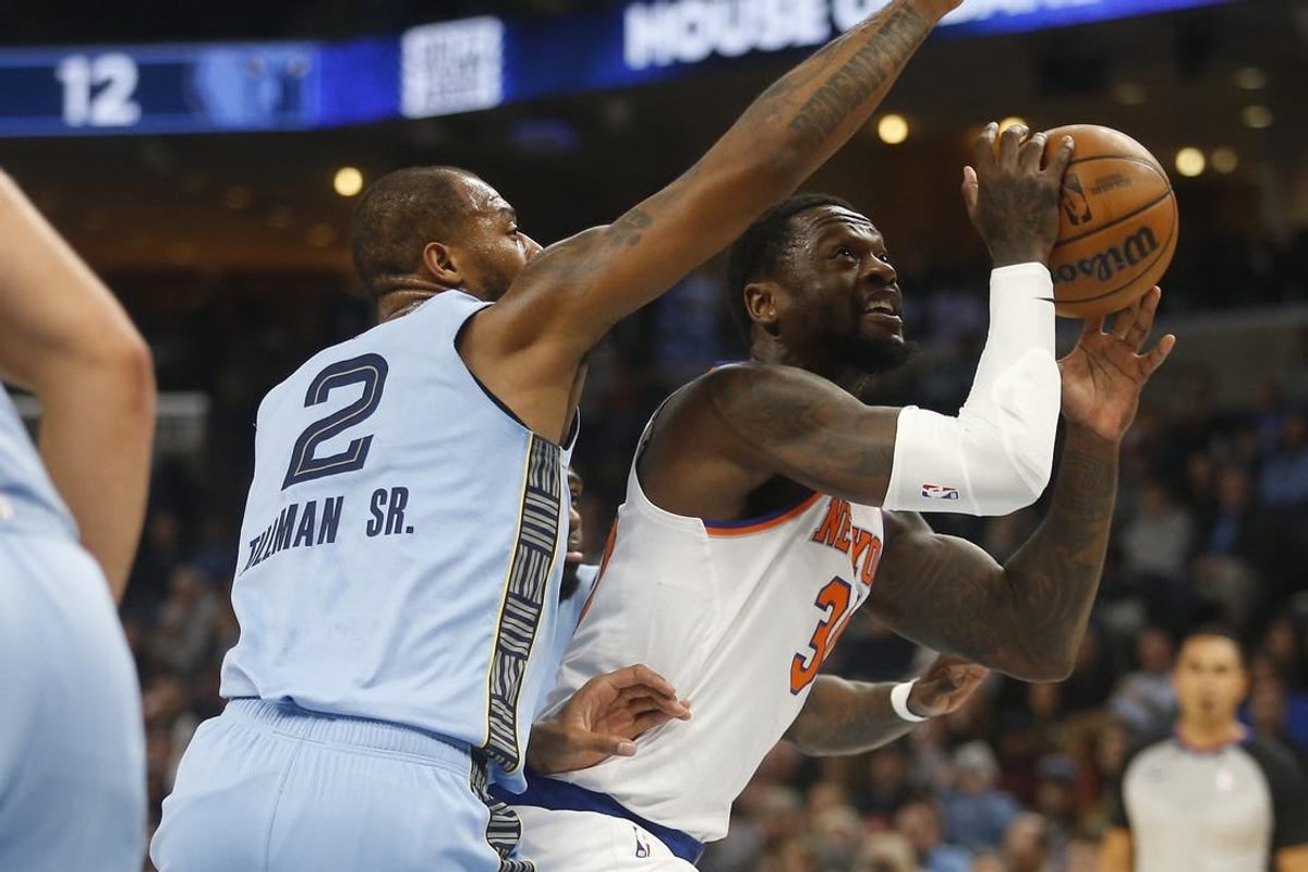 Jan 13, 2024; Memphis, Tennessee, USA; New York Knicks forward Julius Randle (30) drives to the basket as Memphis Grizzlies forward Xavier Tillman (2) defends during the first half at FedExForum.