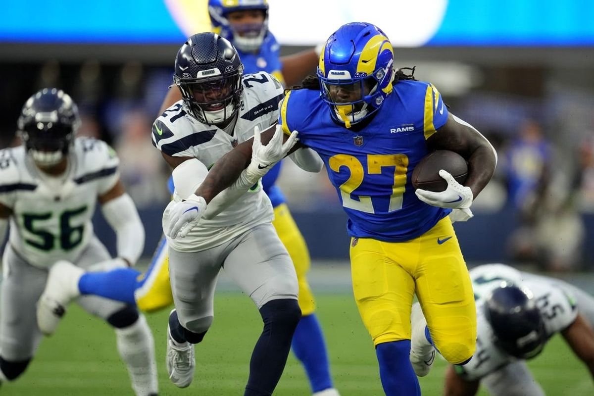 Nov 19, 2023; Inglewood, California, USA; Los Angeles Rams running back Darrell Henderson Jr. (27) runs against Seattle Seahawks cornerback Devon Witherspoon (21) in the second half at SoFi Stadium.