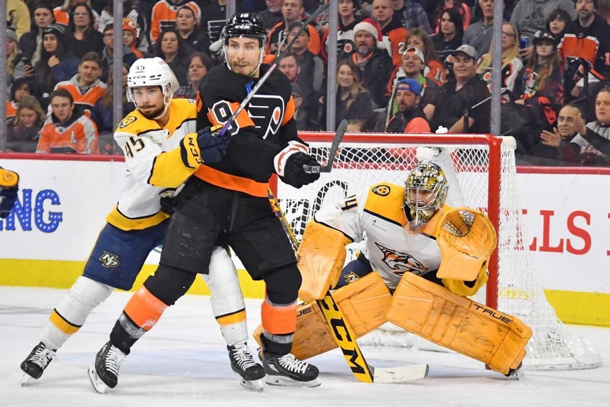 Dec 21, 2023; Philadelphia, Pennsylvania, USA; Philadelphia Flyers right wing Garnet Hathaway (19) and Nashville Predators defenseman Alexandre Carrier (45) battle for the puck in front of goaltender Juuse Saros (74) during the second period at Wells Fargo Center.