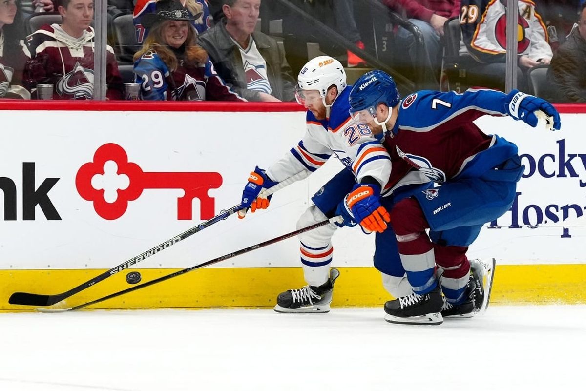 Apr 18, 2024; Denver, Colorado, USA; Edmonton Oilers right wing Connor Brown (28) and Colorado Avalanche defenseman Devon Toews (7) battle for the puck in the first period at Ball Arena.