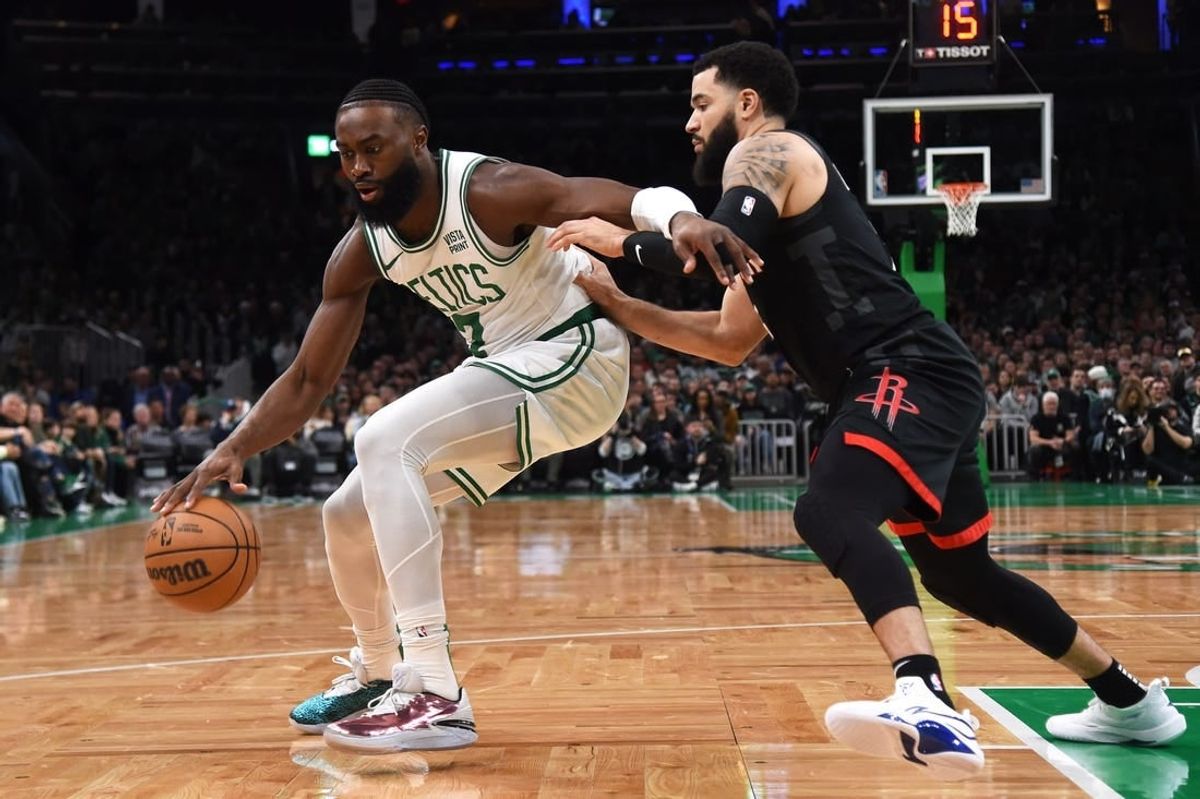 Jan 13, 2024; Boston, Massachusetts, USA; Boston Celtics guard Jaylen Brown (7) controls the ball while Houston Rockets guard Fred VanVleet (5) defends during the first half at TD Garden.