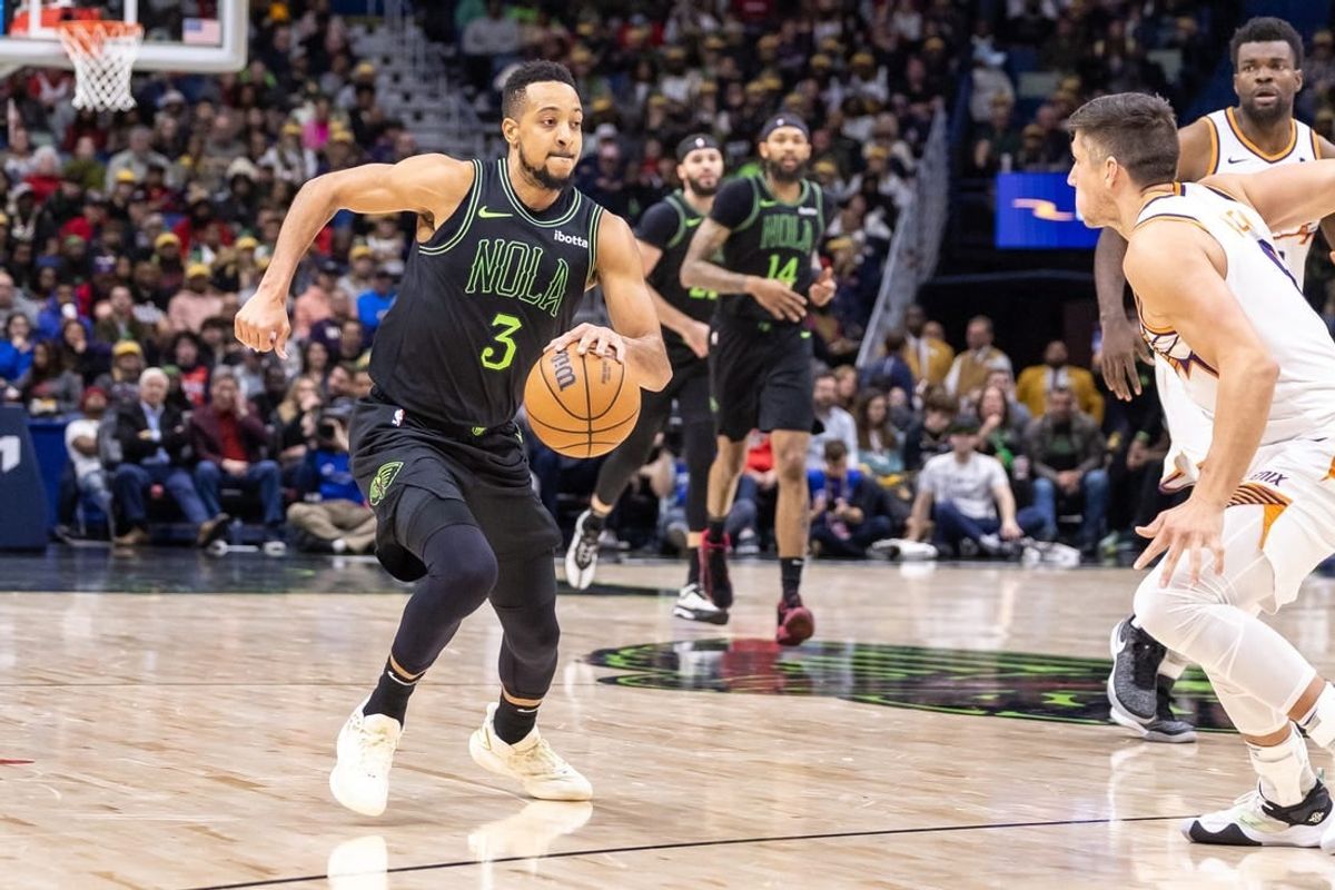 Jan 19, 2024; New Orleans, Louisiana, USA;  New Orleans Pelicans guard CJ McCollum (3) dribbles against Phoenix Suns guard Grayson Allen (8) during the second half at Smoothie King Center.
