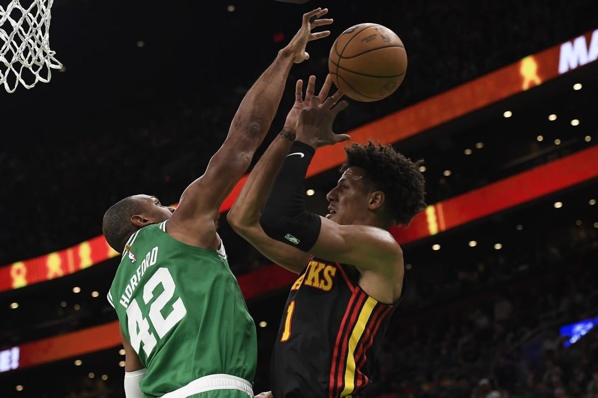 Feb 7, 2024; Boston, Massachusetts, USA;  Boston Celtics center Al Horford (42) blocks the shot of Atlanta Hawks forward Jalen Johnson (1) during the first half at TD Garden.