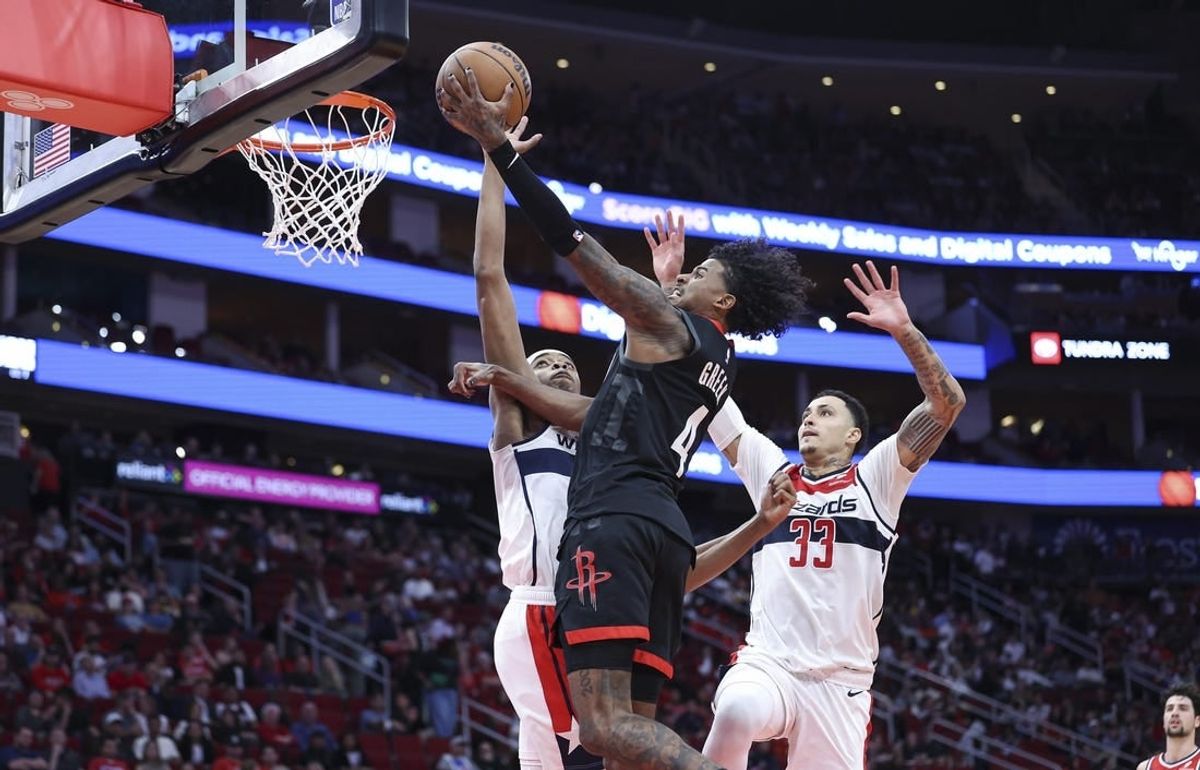 Mar 14, 2024; Houston, Texas, USA; Houston Rockets guard Jalen Green (4) drives to the basket as Washington Wizards guard Bilal Coulibaly (0) defends during the second quarter at Toyota Center.