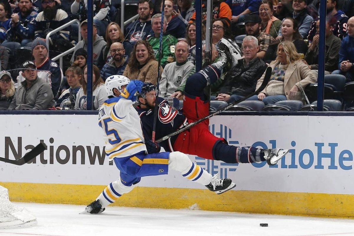 Feb 23, 2024; Columbus, Ohio, USA; Buffalo Sabres defenseman Connor Clifton (75) checks Columbus Blue Jackets center Sean Kuraly (7) during the first period at Nationwide Arena.