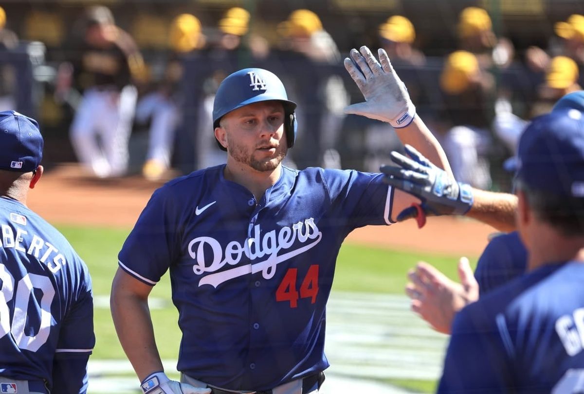 Feb 22, 2024; Peoria, Arizona, USA; Los Angeles Dodgers infielder Kevin Padlo celebrates with teammates after hitting a home run against the San Diego Padres during a spring training game at Peoria Sports Complex.
