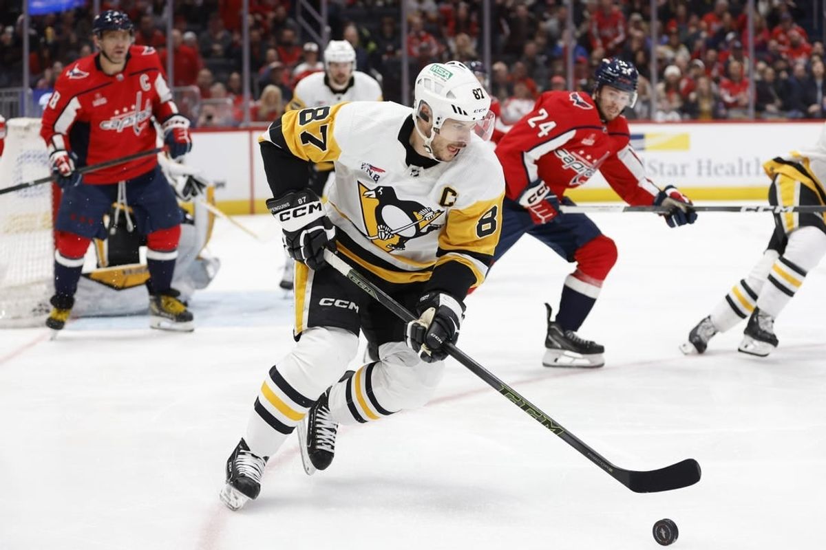 Apr 4, 2024; Washington, District of Columbia, USA; Pittsburgh Penguins center Sidney Crosby (87) skates with the puck as Washington Capitals center Connor McMichael (24) chases in the first period at Capital One Arena.