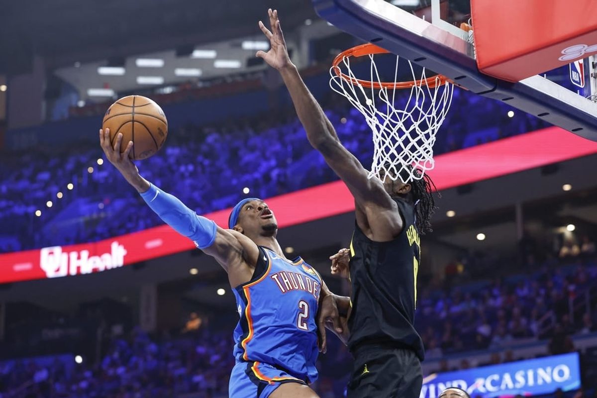 Mar 20, 2024; Oklahoma City, Oklahoma, USA; Oklahoma City Thunder guard Shai Gilgeous-Alexander (2) goes to the basket as Utah Jazz forward Taylor Hendricks (0) defends during the second quarter at Paycom Center.
