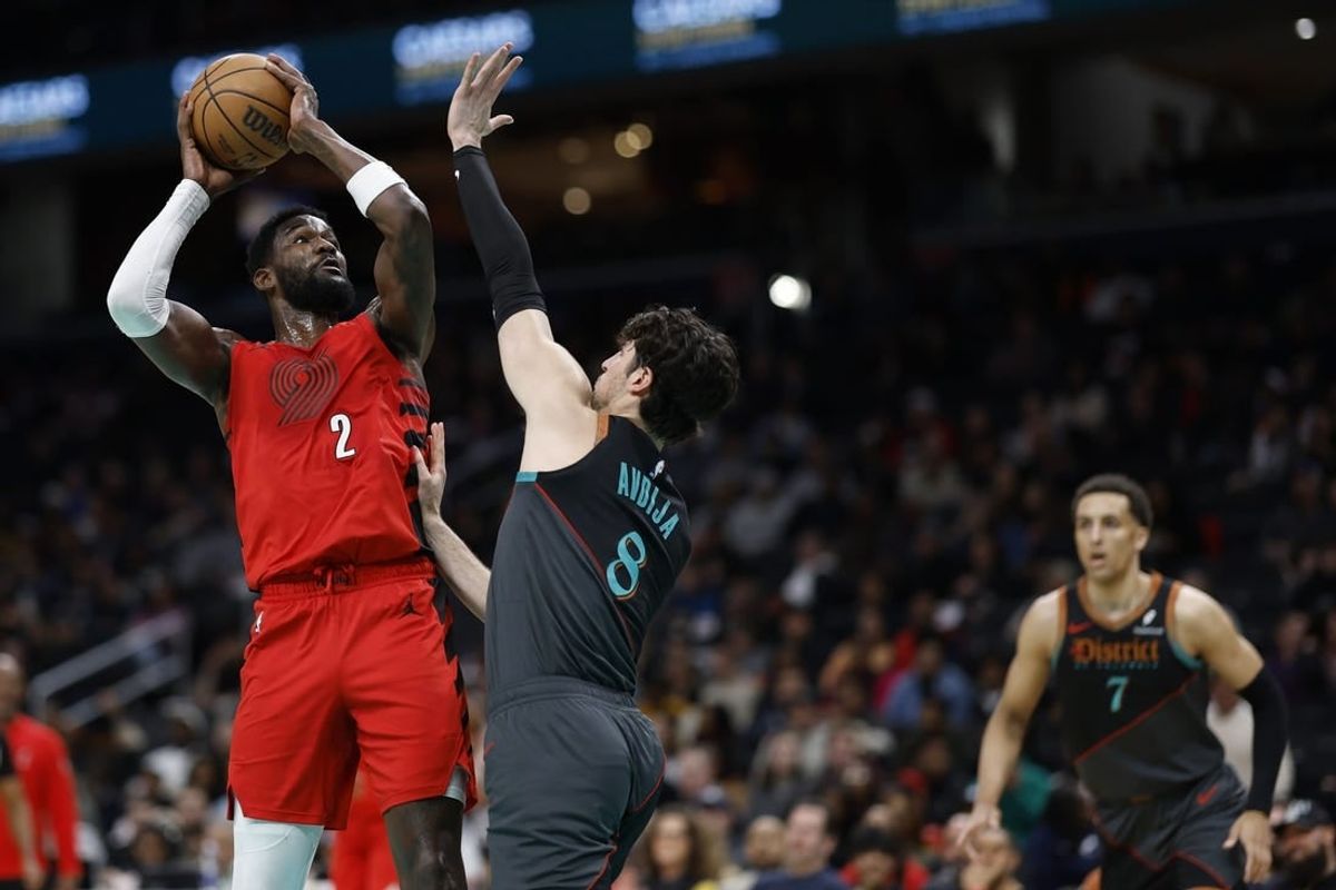 Apr 5, 2024; Washington, District of Columbia, USA;  Portland Trail Blazers center Deandre Ayton (2) shoots the ball as Washington Wizards forward Deni Avdija (8) defends in the first half at Capital One Arena.