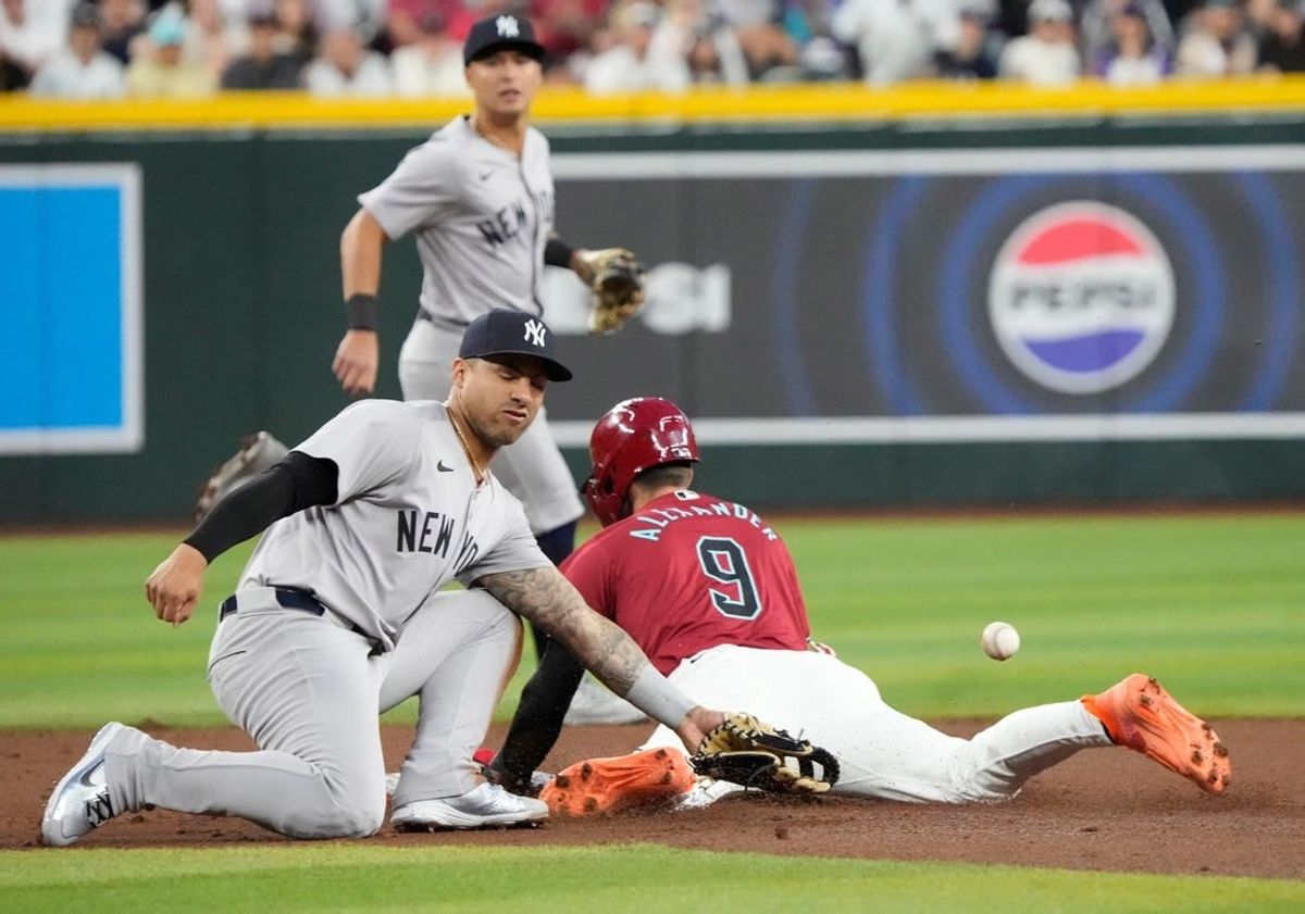 Arizona Diamondbacksâ€™ Blaze Alexander (9) steals second base as the ball gets away from New York Yankees second baseman Gleyber Torres (25) during the first inning at Chase Field in Phoenix on April 2, 2024.
